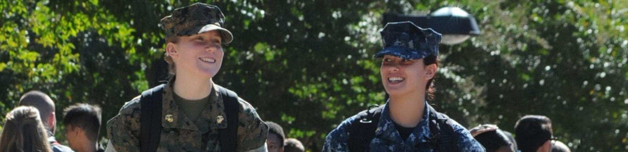 Midshipmen, both female in uniform, walking to class